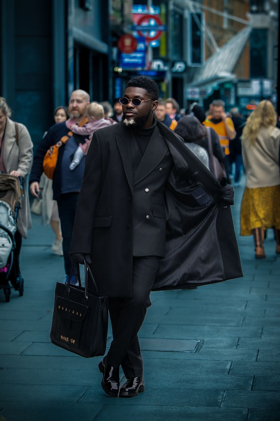 Man in a black coat at Oxford Circus, London — cinematic street portrait