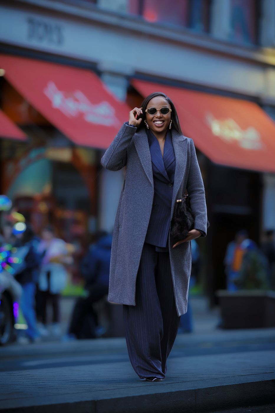 Woman in a grey coat on a Soho street, London — editorial street portrait