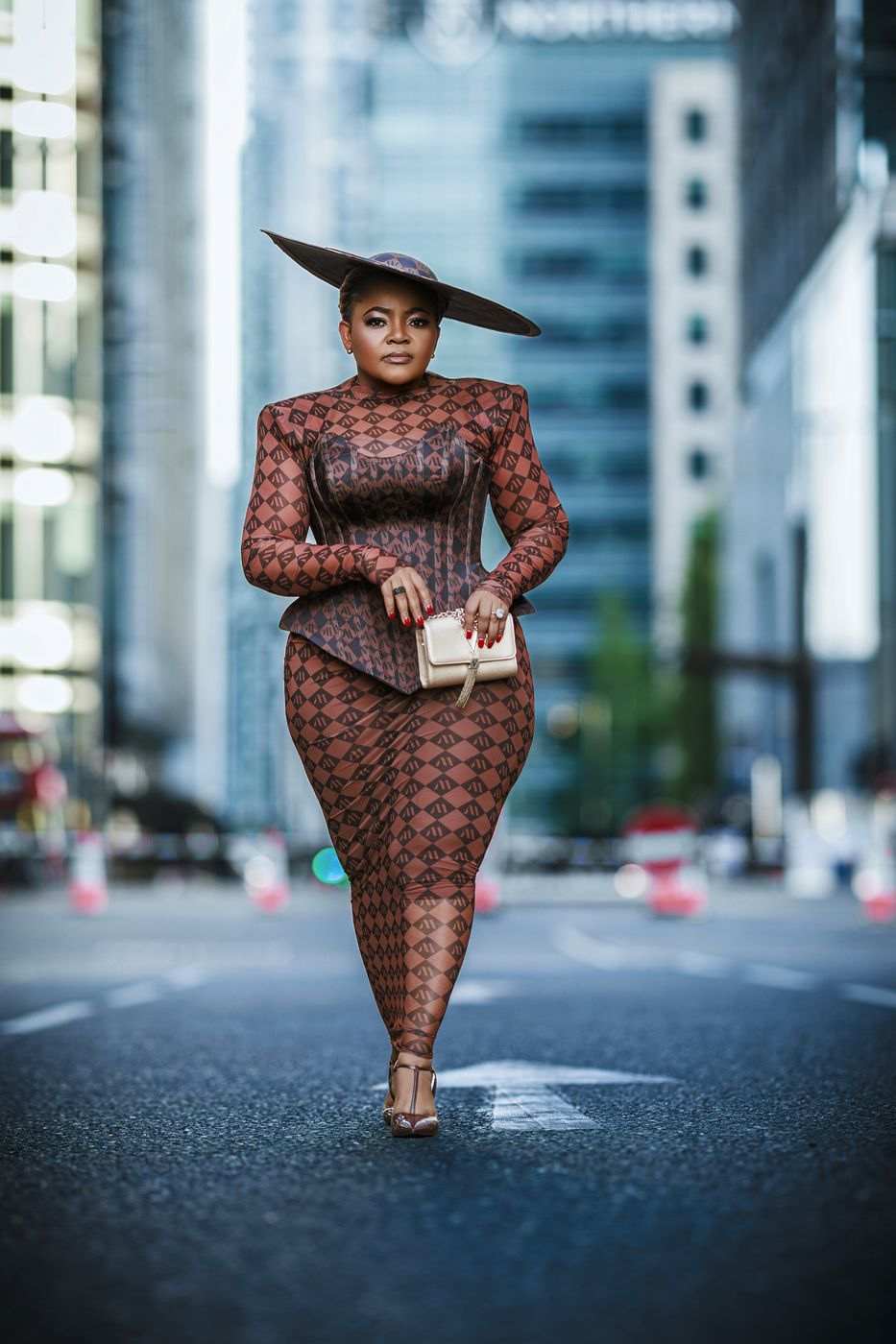 Woman in a patterned dress and wide-brim hat at Canary Wharf — London street portrait